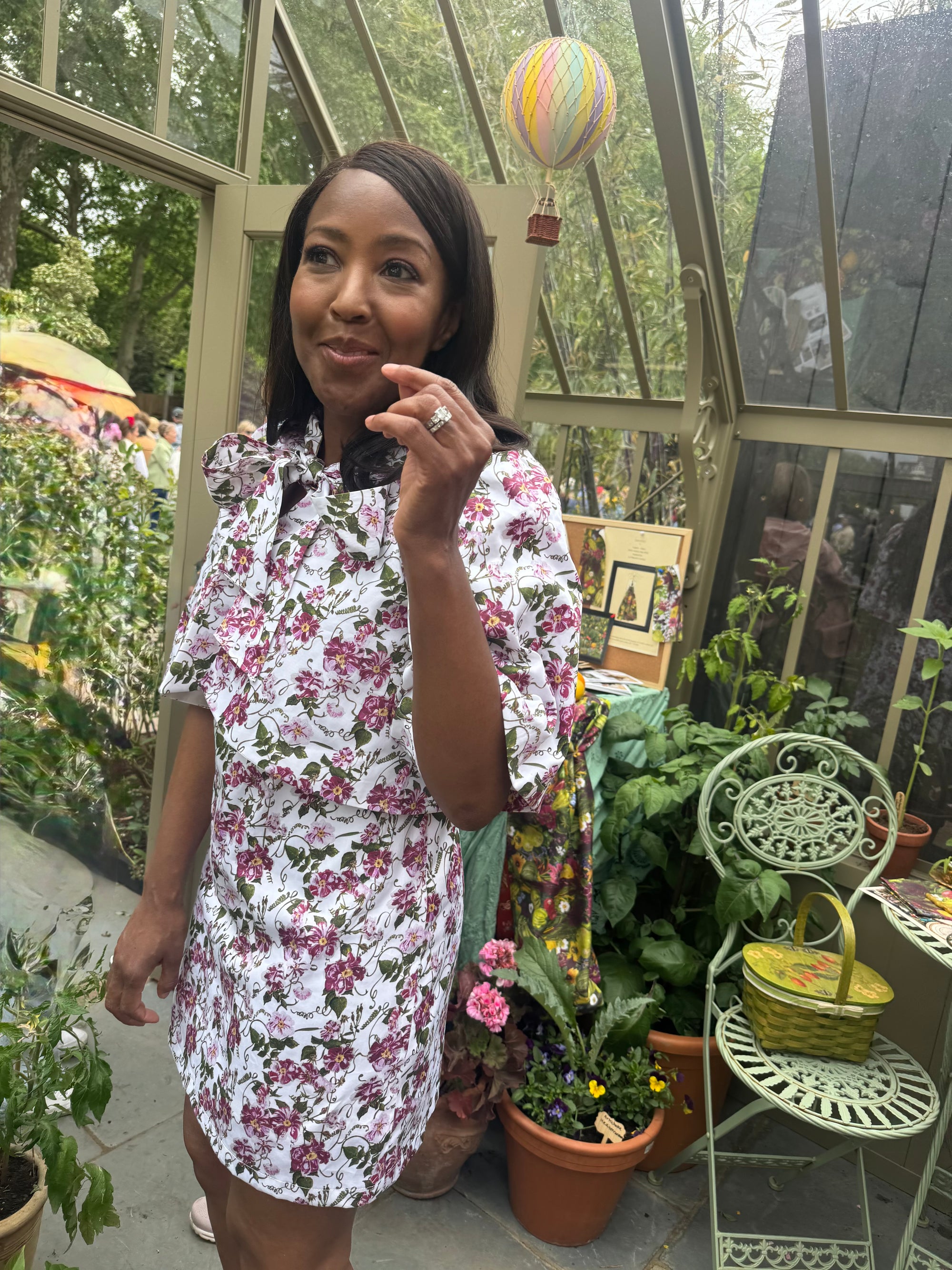 Angellica Bell at RHS Chelsea 2026 Alitex Greenhouse Floral Bow Neck Dress Bow Neck Swing Jacket and Shift Dress. Pink and white Floral Bow Neck outfit Chelsea Lorelei London Pink Floral Print Inspired by The Kings Rose. Floral Mini Dress with Bow and sleeves. What was Angellica Bell wearing at RHS Chelsea on Friday 22nd May 2026. Made in The Uk, Sustainable Fashion Brand. August Beth Le Manoir