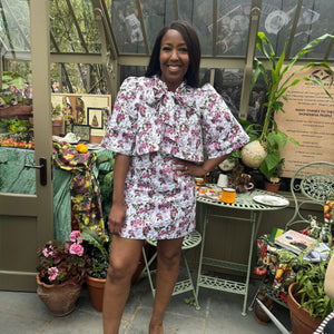 Angellica Bell at RHS Chelsea 2026 Alitex Greenhouse Floral Bow Neck Dress Bow Neck Swing Jacket and Shift Dress. Pink and white Floral Bow Neck outfit Chelsea Lorelei London Pink Floral Print Inspired by The Kings Rose. Floral Mini Dress with Bow and sleeves. What was Angellica Bell wearing at RHS Chelsea on Friday 22nd May 2026. Made in The Uk, Sustainable Fashion Brand