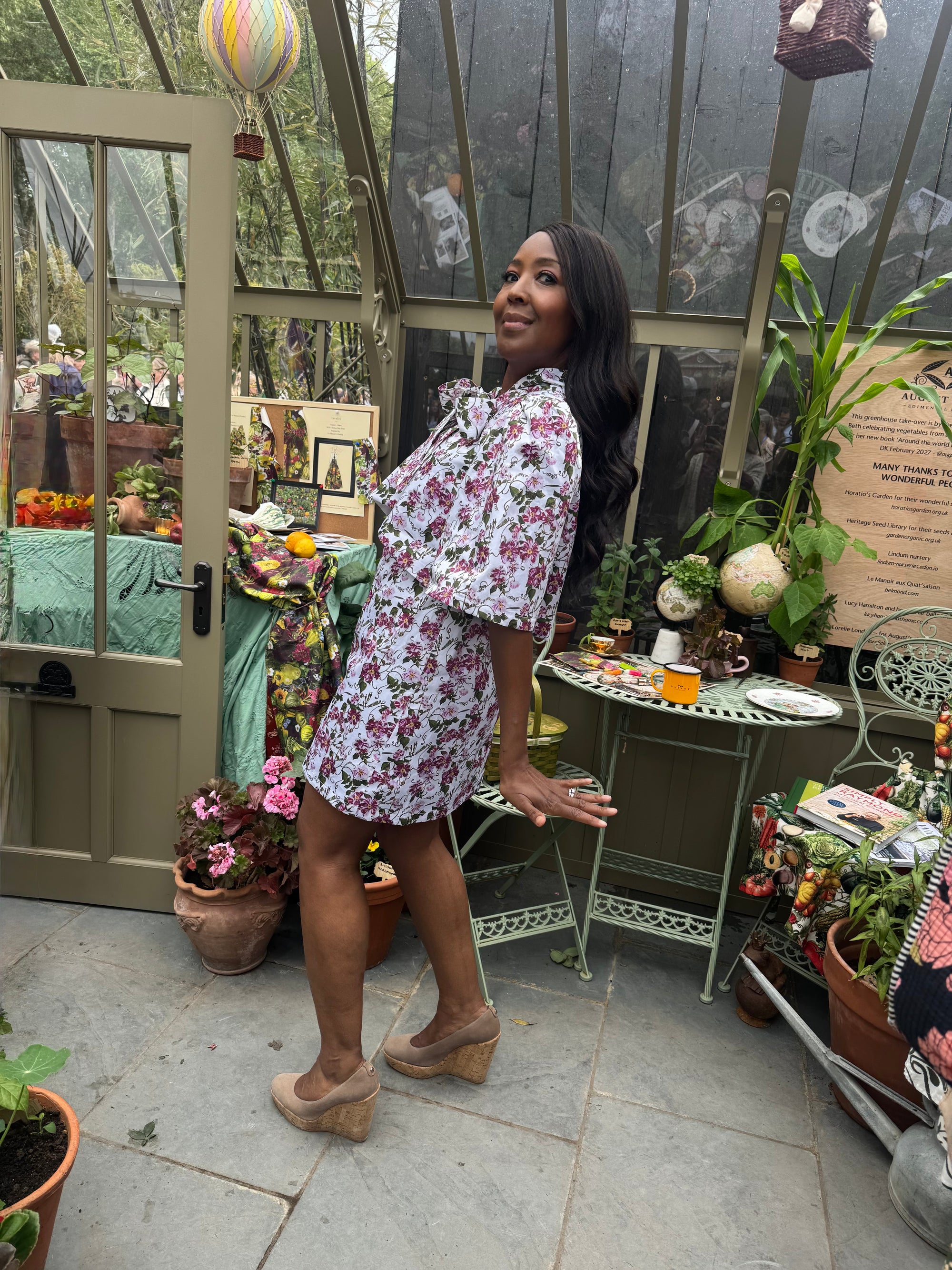 Angellica Bell at RHS Chelsea 2026 Alitex Greenhouse Floral Bow Neck Dress Bow Neck Swing Jacket and Shift Dress. Pink and white Floral Bow Neck outfit Chelsea Lorelei London Pink Floral Print Inspired by The Kings Rose. Floral Mini Dress with Bow and sleeves. What was Angellica Bell wearing at RHS Chelsea on Friday 22nd May 2026. Made in The Uk, Sustainable Fashion Brand. August Beth vegetable emporium. Presenters outfits at Chelsea