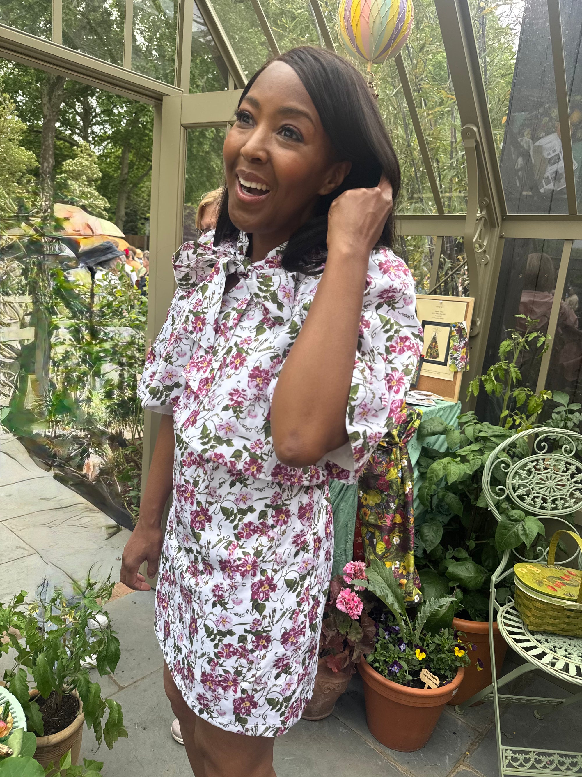 Angellica Bell at RHS Chelsea 2026 Alitex Greenhouse Floral Bow Neck Dress Bow Neck Swing Jacket and Shift Dress. Pink and white Floral Bow Neck outfit Chelsea Lorelei London Pink Floral Print Inspired by The Kings Rose. Floral Mini Dress with Bow and sleeves. What was Angellica Bell wearing at RHS Chelsea on Friday 22nd May 2026. Made in The Uk, Sustainable Fashion Brand. August Beth Le Manoir