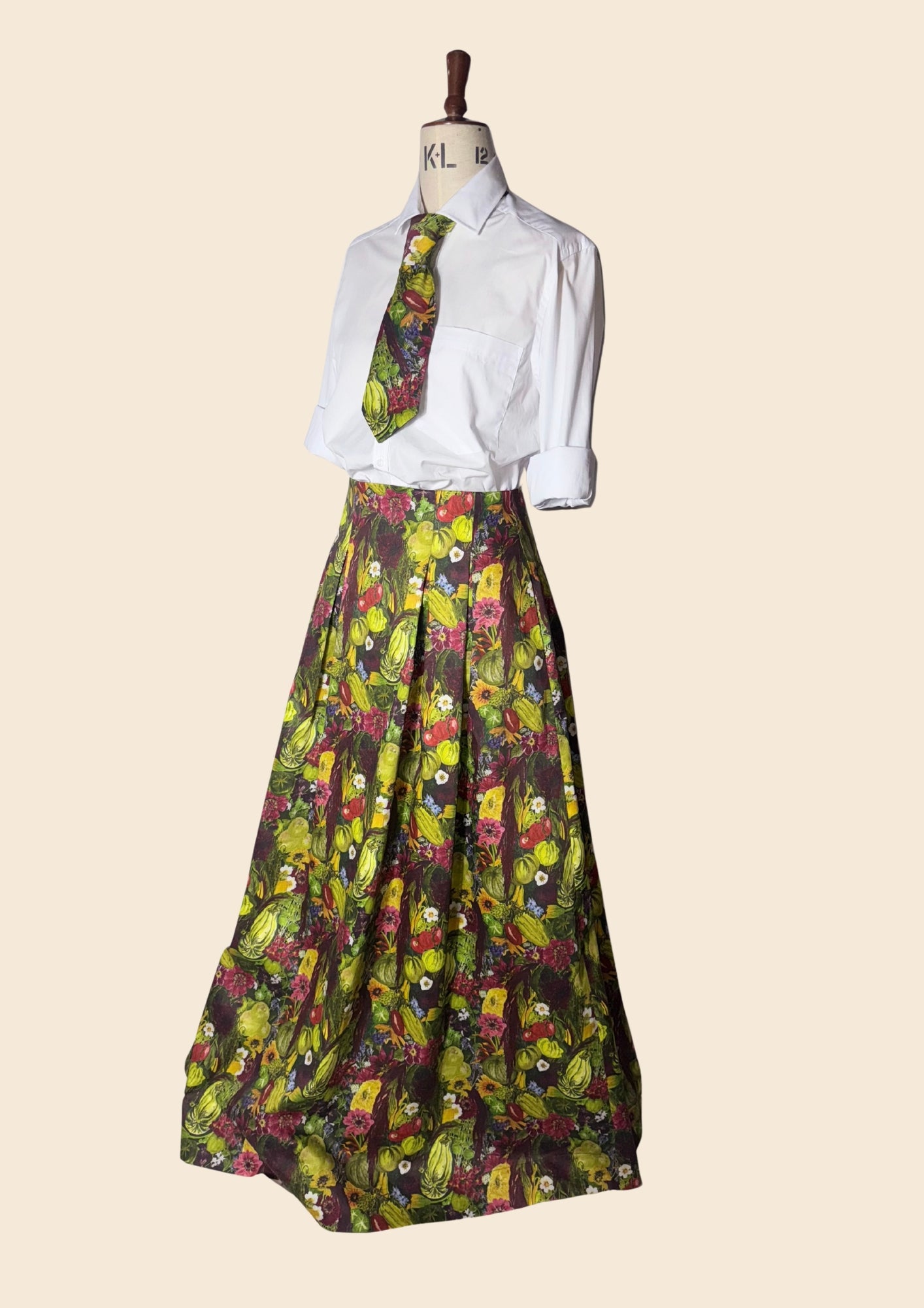 Side angle view of the August Beth bespoke skirt and tie designed for RHS Chelsea Press Day 2026. Vegetable print inspired by the gardens at Le manoir and The Around The World in 80 Seeds.