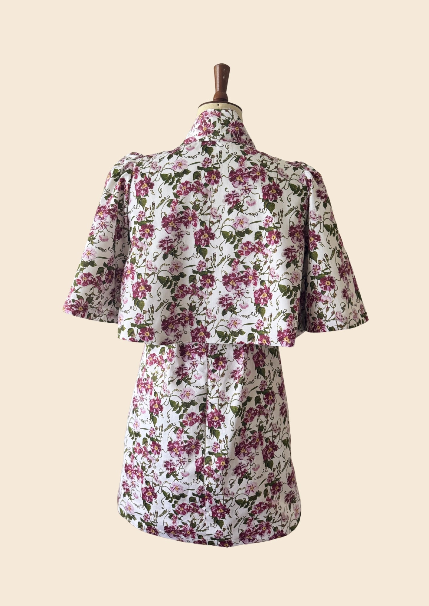 The_Bow_Swing_Jacket_Shift_Dress_in_a_trailing_Pink_Floral_Rose_print_inspired_by_The_Kings_Rose.Flat lay as seen on Angellica Bell at RHS Chelsea 2026. Iplayer Episode 9 on the BBC with MAry Berry giving out THe people choice award.