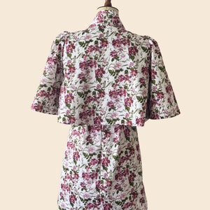 The_Bow_Swing_Jacket_Shift_Dress_in_a_trailing_Pink_Floral_Rose_print_inspired_by_The_Kings_Rose.Flat lay as seen on Angellica Bell at RHS Chelsea 2026. Iplayer Episode 9 on the BBC with MAry Berry giving out THe people choice award.