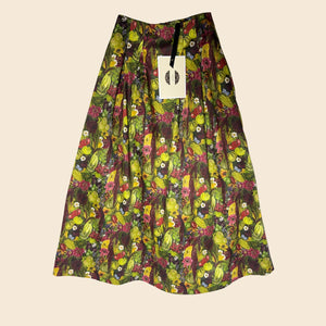 Flat lay image of the Vegetable Print August skirt created for August Beth to wear at RHS Chelsea, in her Around the world in 80 seeds Vegetable Emporium Alitex greenhouse takeover.  Designed by Lorelei London Sustainable brand made in the UK Hand drawn prints. Wearable stories. Timeless pieces to treasure.