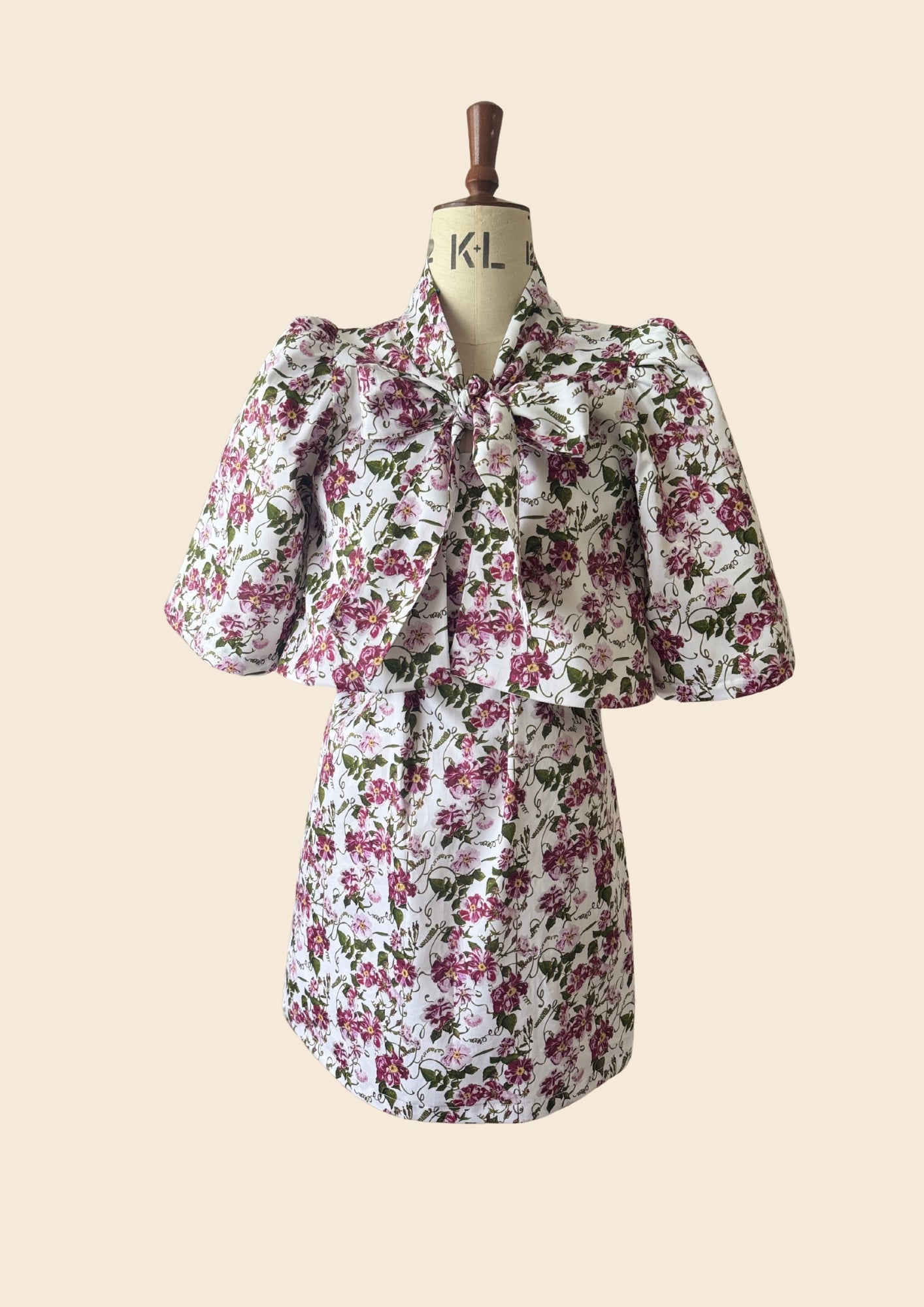 The Bow Swing Jacket & Shift Dress  (Two Piece) in a trailing Pink Floral Rose print inspired by The Kings Rose. Full Front flat lay image of the design on the mannequin. As seen on Angellica Bell at RHS Chelsea on Friday 22nd May. Sold Seperately 
